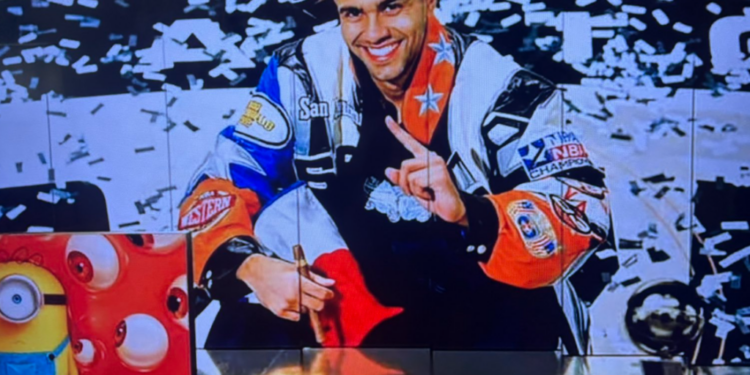 San Antonio Spurs legend Tony Parker poses in a racing jacket with confetti falling in the background. ESPN is under scrutiny after using this AI-generated image during Game 1 of the NBA Finals Wednesday night.