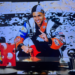 San Antonio Spurs legend Tony Parker poses in a racing jacket with confetti falling in the background. ESPN is under scrutiny after using this AI-generated image during Game 1 of the NBA Finals Wednesday night.