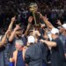 The New York Knicks players and staff celebrate with the Larry O'Brien Championship Trophy after winning Game 5 of the 2026 NBA Finals.