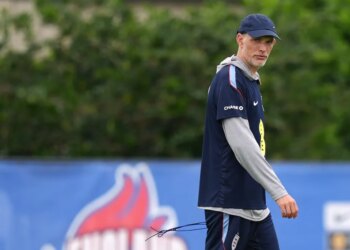 England head coach Thomas Tuchel walks on a field during practice.