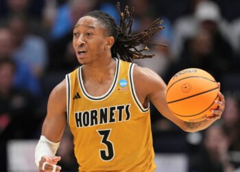 Alabama State guard CJ Hines dribbling a basketball during a game.