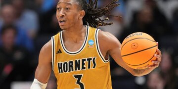Alabama State guard CJ Hines dribbling a basketball during a game.