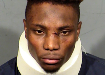 Booking photo of former Las Vegas Raiders wide receiver Henry Ruggs III wearing a neck brace.