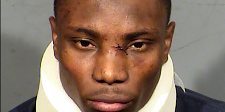 Booking photo of former Las Vegas Raiders wide receiver Henry Ruggs III wearing a neck brace.