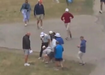 A fan picks up Rory McIlroy's ball after a shot on the fourth hole during the first round of the U.S. Open on June 18, 2026.