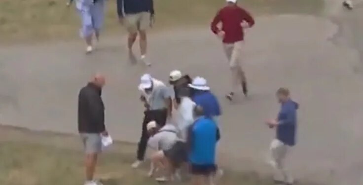 A fan picks up Rory McIlroy's ball after a shot on the fourth hole during the first round of the U.S. Open on June 18, 2026.
