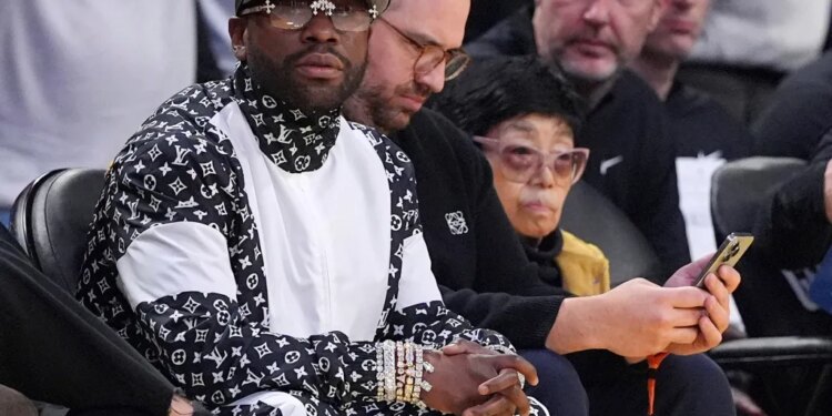 Floyd Mayweather sitting courtside during an NBA basketball game.