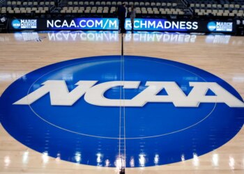 NCAA logo at center court in an arena.