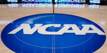 NCAA logo at center court in an arena.