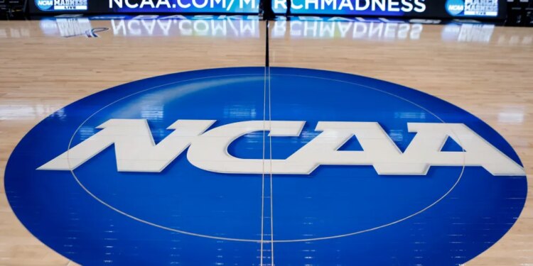 NCAA logo at center court in an arena.