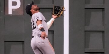 New York Yankees' José Caballero catches a flyout hit by Boston Red Sox's Wilyer Abreu during the seventh inning of a baseball game, Thursday, June 25, 2026, in Boston.