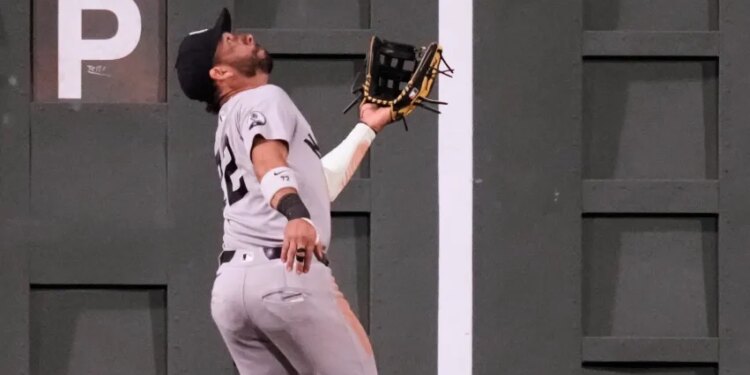 New York Yankees' José Caballero catches a flyout hit by Boston Red Sox's Wilyer Abreu during the seventh inning of a baseball game, Thursday, June 25, 2026, in Boston.