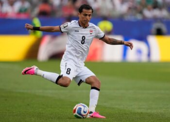 Iraq's Ibrahim Bayesh (8) passes the ball during a soccer match.