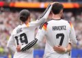 Germany's Leroy Sane and Kai Havertz celebrate after scoring the seventh goal during a World Cup Group E soccer match.