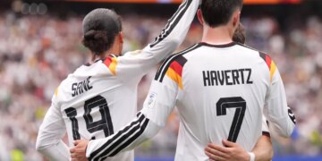 Germany's Leroy Sane and Kai Havertz celebrate after scoring the seventh goal during a World Cup Group E soccer match.