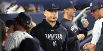 Giancarlo Stanton of the New York Yankees in the dugout.