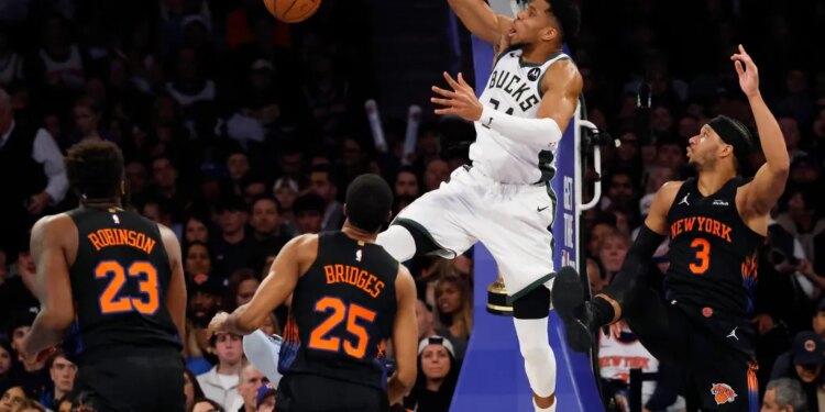 Giannis Antetokounmpo of the Milwaukee Bucks slams the ball.