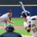 Baseball pitcher Adrian Houser throwing a pitch to a batter.
