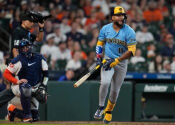 Jackson Chourio of the Milwaukee Brewers runs after hitting a fly out.