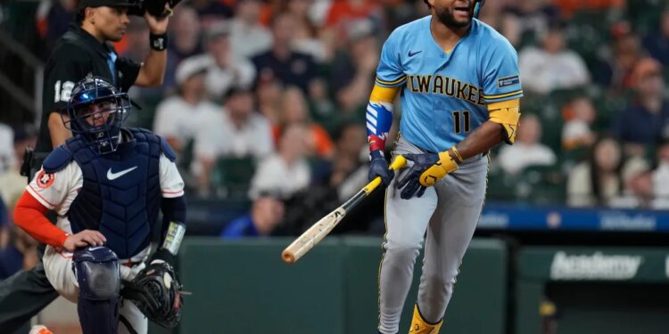 Jackson Chourio of the Milwaukee Brewers runs after hitting a fly out.