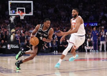 San Antonio Spurs guard De'Aaron Fox drives the ball downcourt as New York Knicks guard Mikal Bridges gives chase during Game 3 of the NBA Finals.