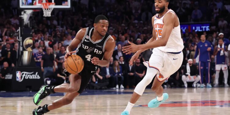 San Antonio Spurs guard De'Aaron Fox drives the ball downcourt as New York Knicks guard Mikal Bridges gives chase during Game 3 of the NBA Finals.