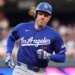 A Dodgers baseball player in a blue uniform and helmet running.