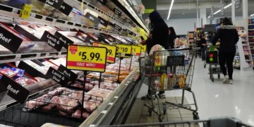 Shoppers at a grocery store stocking up on meat and other supplies before a winter storm.
