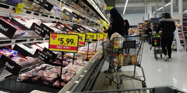 Shoppers at a grocery store stocking up on meat and other supplies before a winter storm.