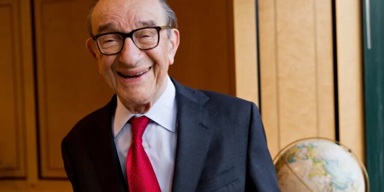 Economist Alan Greenspan smiles, wearing glasses, a suit jacket, and a red tie.