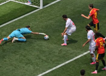Iran goalkeeper Alireza Beiranvand saves the soccer ball during a World Cup match.