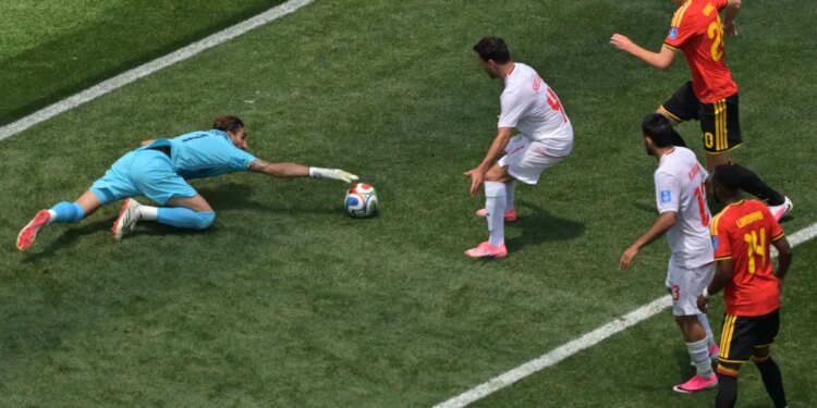 Iran goalkeeper Alireza Beiranvand saves the soccer ball during a World Cup match.