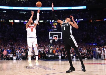 Jalen Brunson #11 sinks a three-point shot over San Antonio Spurs forward Victor Wembanyama #1 to bring the Knicks within one during the fourth quarter.
