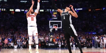 Jalen Brunson #11 sinks a three-point shot over San Antonio Spurs forward Victor Wembanyama #1 to bring the Knicks within one during the fourth quarter.