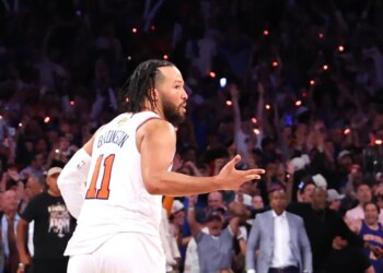 Jalen Brunson #11 reacts after he sinks a three-point shot over San Antonio Spurs forward Victor Wembanyama #1 to bring the Knicks within one during the fourth quarter.