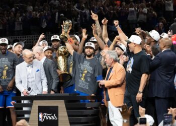 New York Knicks guard Jalen Brunson holds up the MVP trophy after winning the NBA Championship.