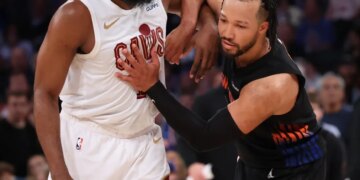 Cleveland Cavaliers guard James Harden and New York Knicks guard Jalen Brunson battle for position.