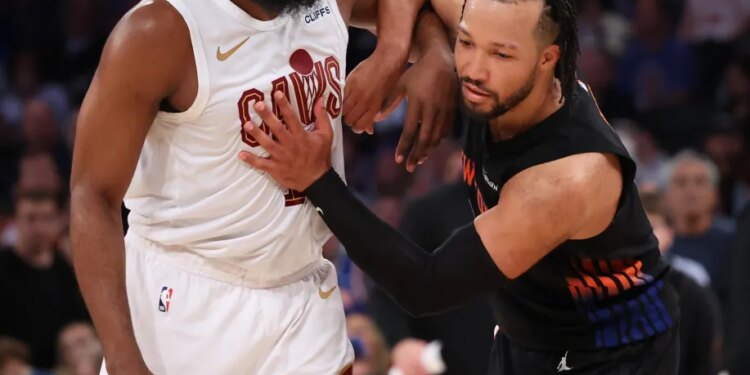 Cleveland Cavaliers guard James Harden and New York Knicks guard Jalen Brunson battle for position.
