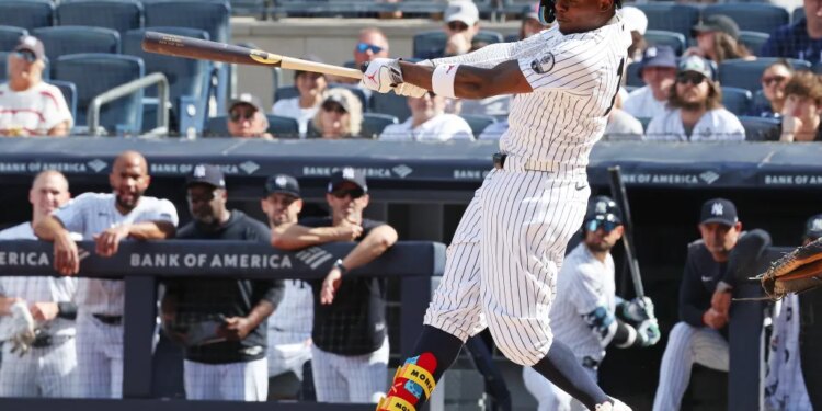 New York Yankees second baseman Jazz Chisholm Jr. in action, swinging the bat.