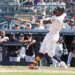 New York Yankees second baseman Jazz Chisholm Jr. in action, swinging the bat.