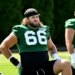 Jets center Joe Tippmann (66) stretches at practice.