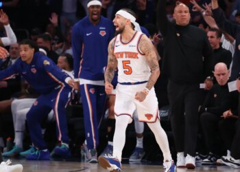 New York Knicks guard Jose Alvarado dribbling the ball against San Antonio Spurs guard Stephon Castle.