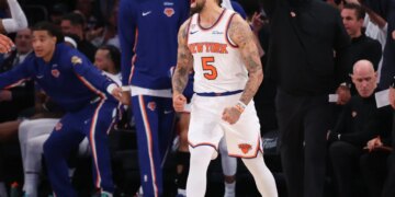 New York Knicks guard Jose Alvarado dribbling the ball against San Antonio Spurs guard Stephon Castle.