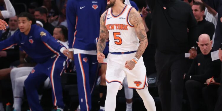 New York Knicks guard Jose Alvarado dribbling the ball against San Antonio Spurs guard Stephon Castle.