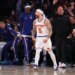 New York Knicks guard Jose Alvarado dribbling the ball against San Antonio Spurs guard Stephon Castle.
