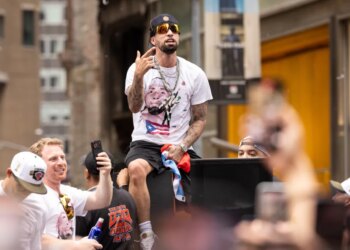 Jose Alvarado celebrating on a parade float during the New York Knicks' 2026 NBA Championship parade.