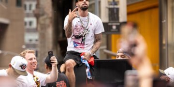 Jose Alvarado celebrating on a parade float during the New York Knicks' 2026 NBA Championship parade.