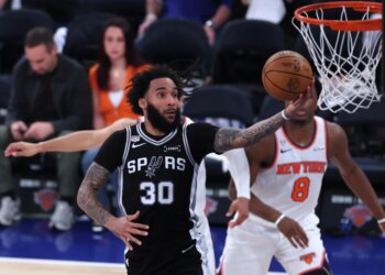 San Antonio Spurs player Julian Champagnie (30) shooting against the New York Knicks in an NBA Finals game.