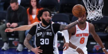 San Antonio Spurs player Julian Champagnie (30) shooting against the New York Knicks in an NBA Finals game.