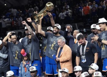A jubilant Karl-Anthony Towns celebrates with owner James Dolan and his Knicks teammates after their 94-90 Game 5 NBA title-clinching win over the Spurs on June 13, 2026 in San Antonio.